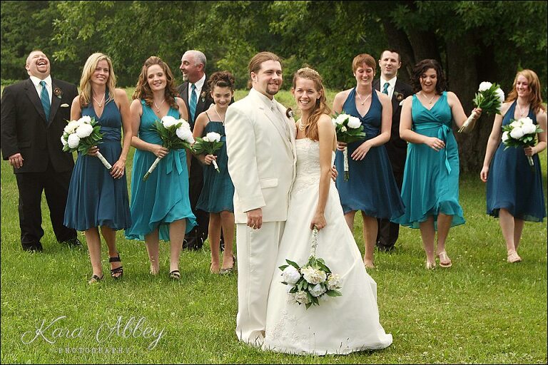 wedding photography bridal party bridesmaids groomsmen laughing bride and groom flowers walking