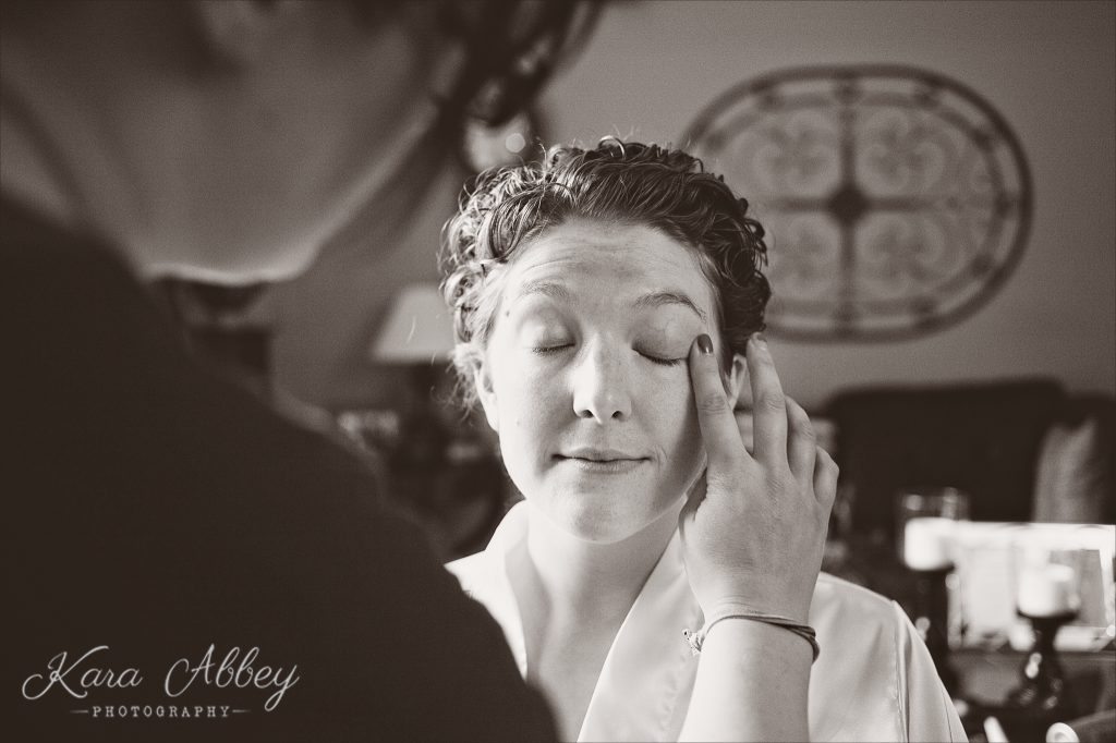 rainy day wedding photography Vestal NY bride getting makeup