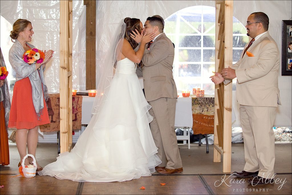 rainy day wedding photographer Tioga Gardens Owego, NY Ceremony First Kiss