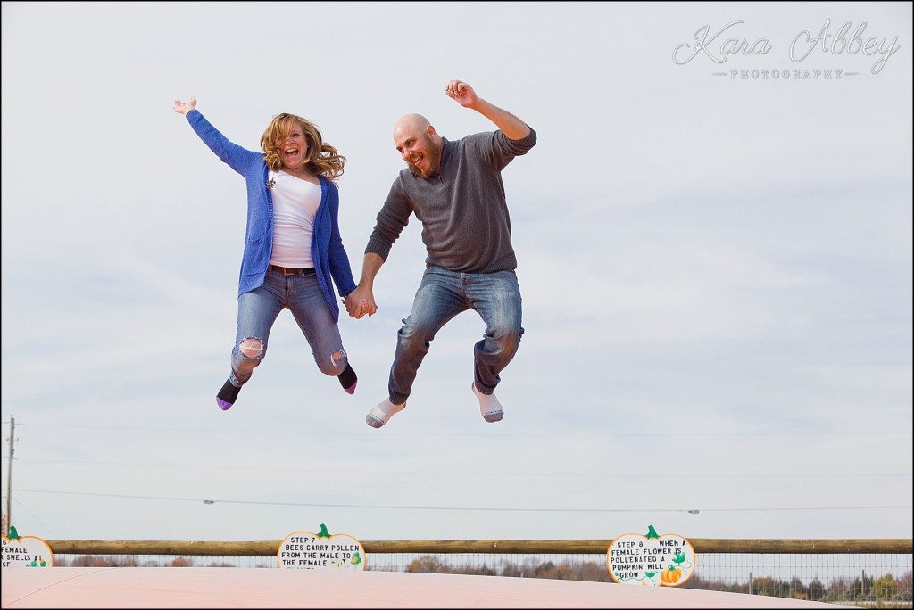 Outdoor fun fall engagement session Roba Family Farms Dalton, PA jumping pumpkin