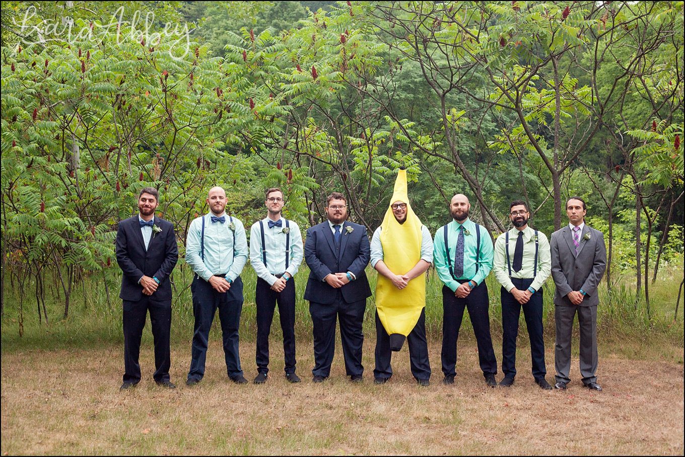 Rustic Pastel Rainy Summer Wedding Groomsmen at Robert Treman State Park in Ithaca, NY with a banana by Kara Abbey Photography in Irwin, PA