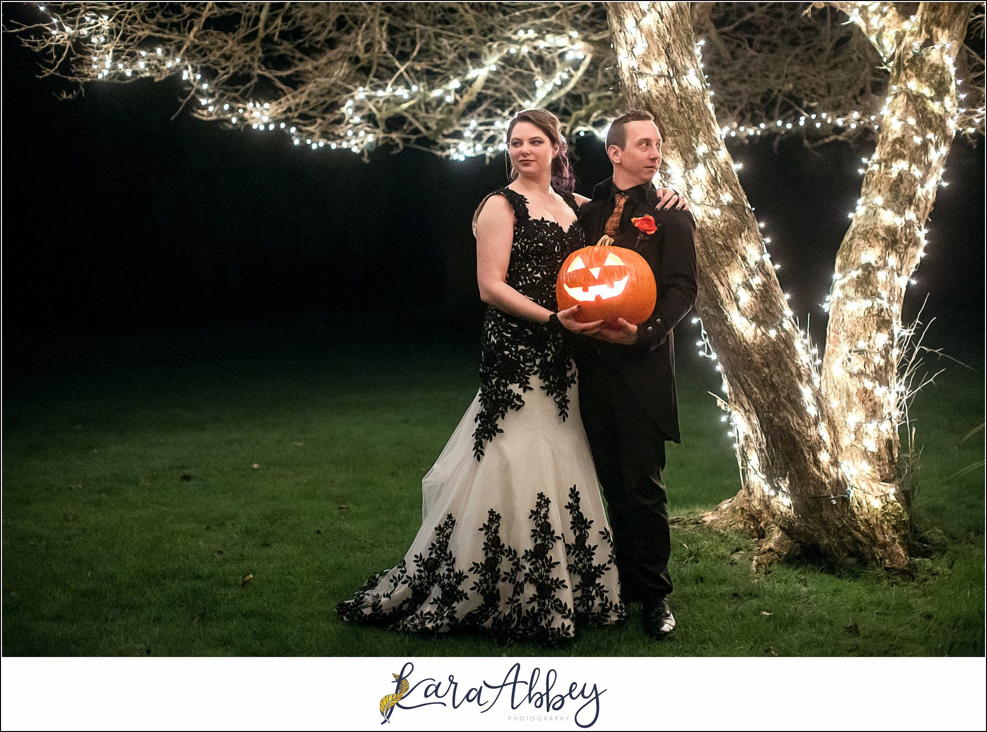 Black and Purple Disney Halloween Themed Fall Wedding at Green Gables in Jennerstown PA - Bride & Groom Night Portrait with Jack-O-Lantern Pumpkin