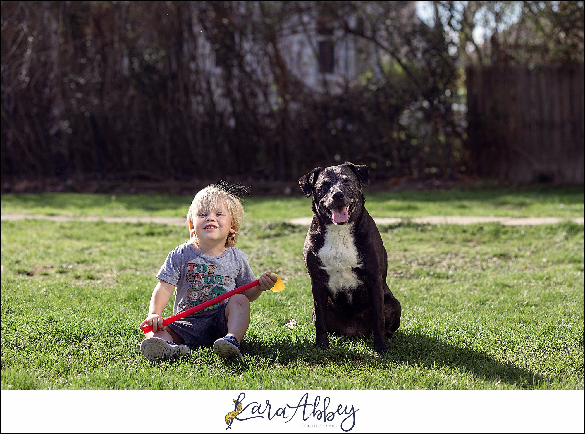 Abbys Saturday Black Lab and Toddler Sitting Outside in Irwin PA